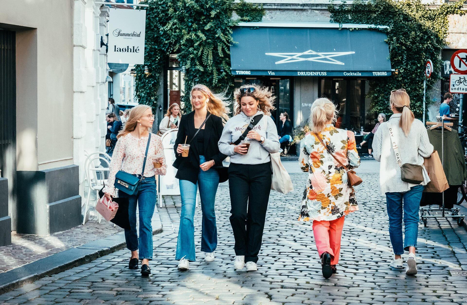 Stroll the Latin Quarter — cozy cafés, local shops, and old-world charm in every corner. (Photographer: Frame & Work) Guests walking through cobbled streets of Aarhus Old Town